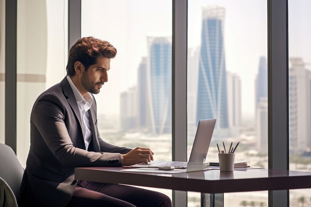 Qatar businessman computer sitting working. AI generated Image by rawpixel.