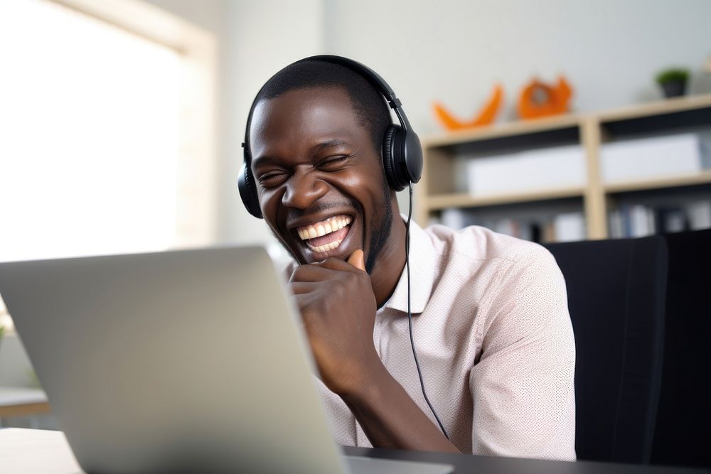 African American man headphones computer laughing. AI generated Image by rawpixel.
