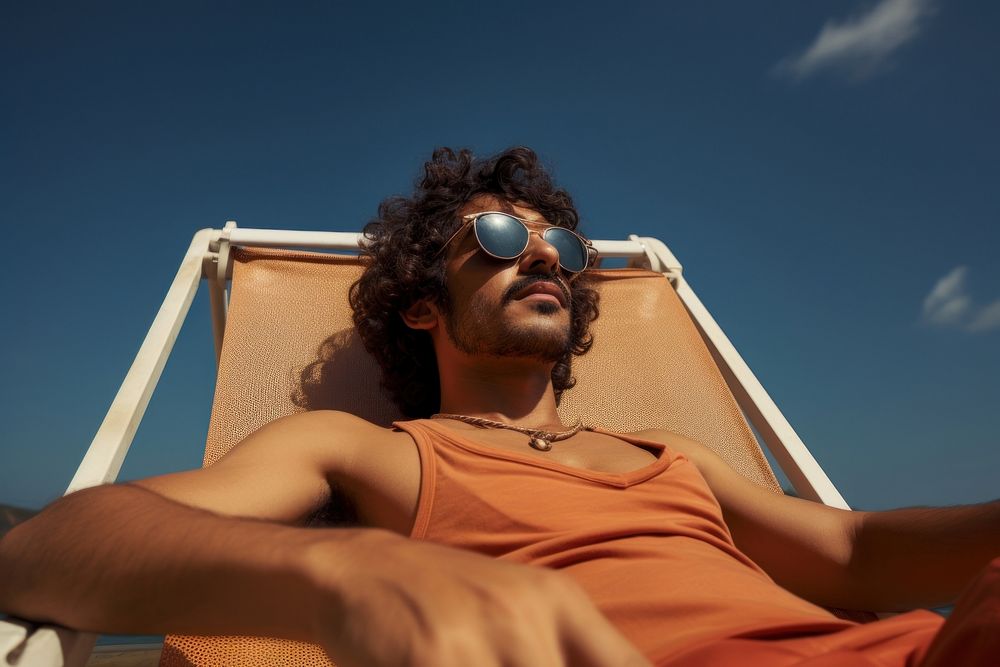 Indian man sunbathing sunglasses portrait. AI generated Image by rawpixel.