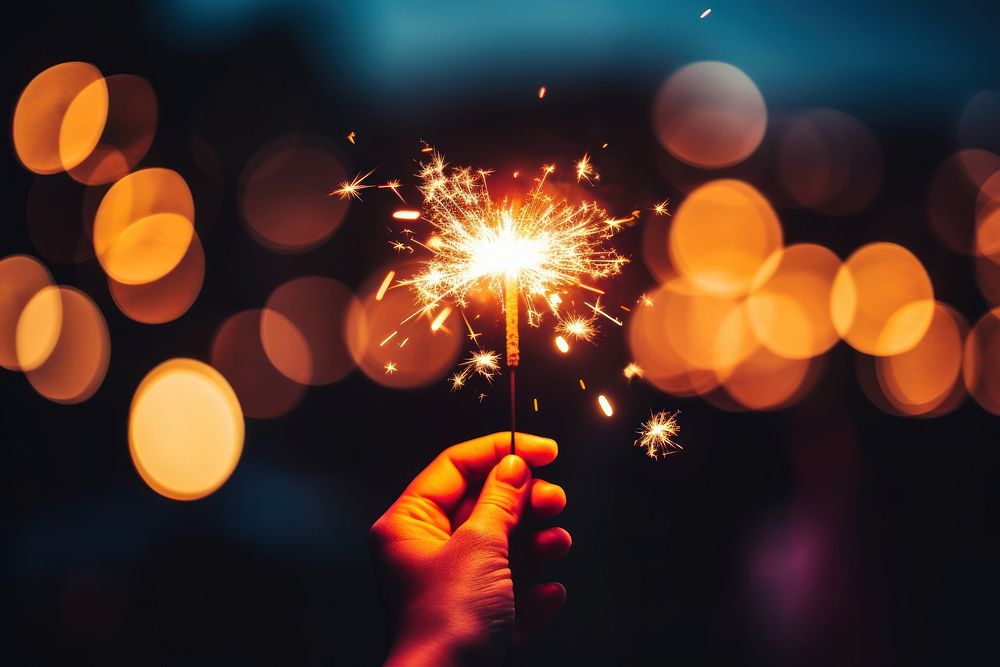 Hand holding burning Sparkler blast celebration fireworks sparkler. AI generated Image by rawpixel.