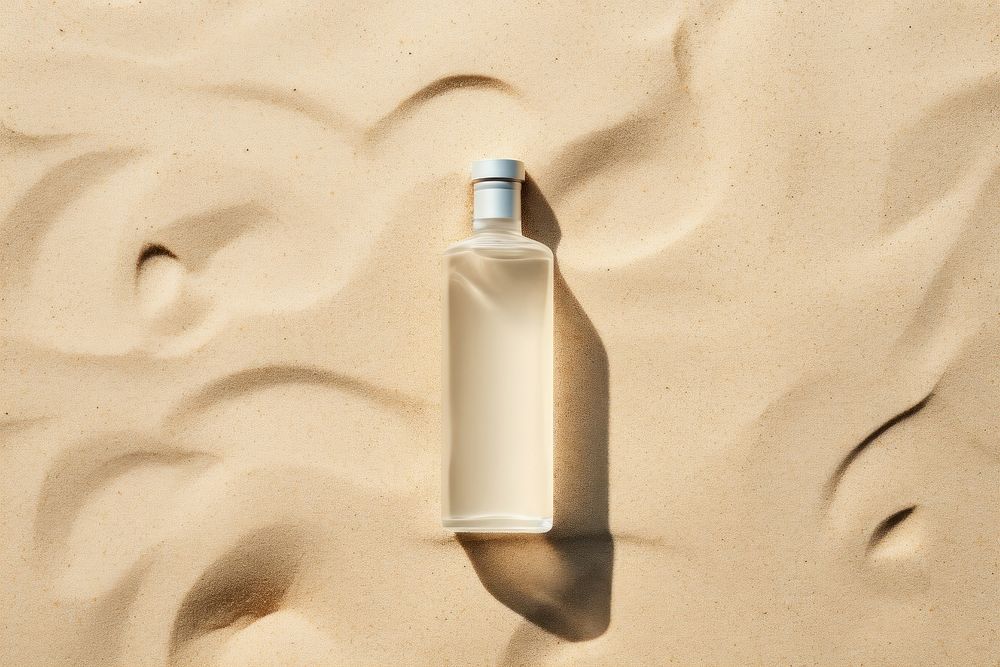 Bottle product sand outdoors nature. AI generated Image by rawpixel.
