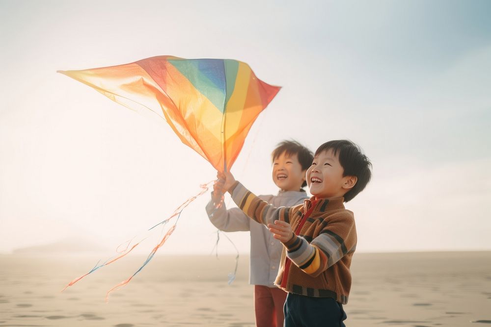 Asian boy playing a colorful kite child toy togetherness. AI generated Image by rawpixel.