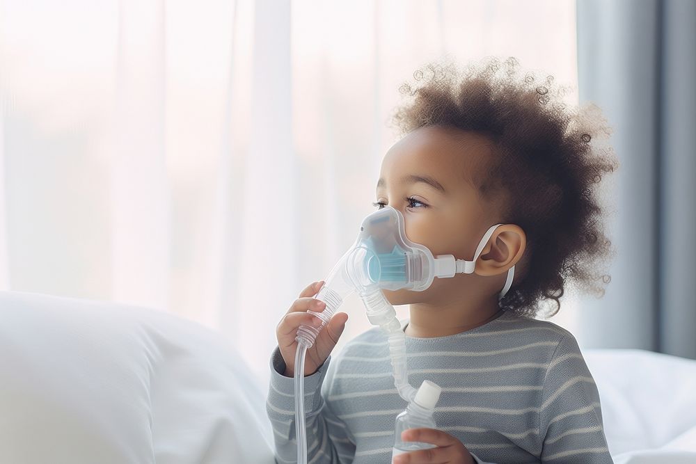 African baby boy use nebulizer mask toothbrush innocence happiness. AI generated Image by rawpixel.