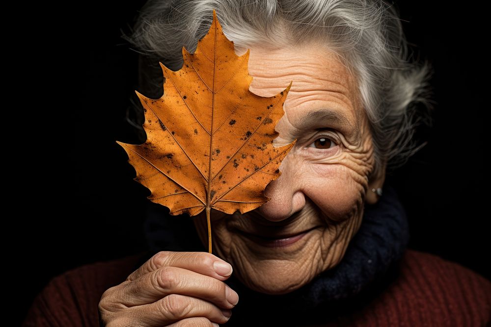 Senior woman leaf portrait holding. AI generated Image by rawpixel.