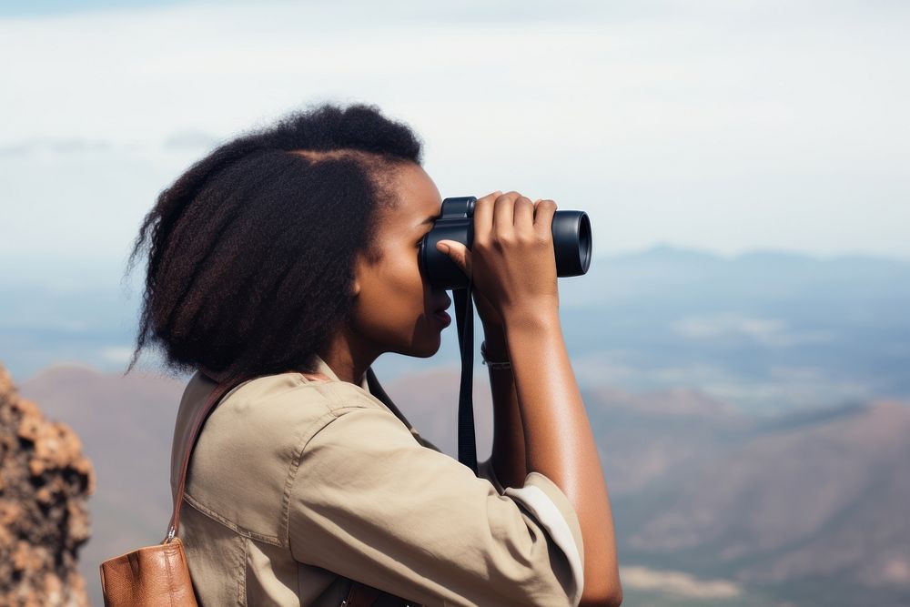 African american woman binoculars mountain travel. AI generated Image by rawpixel.