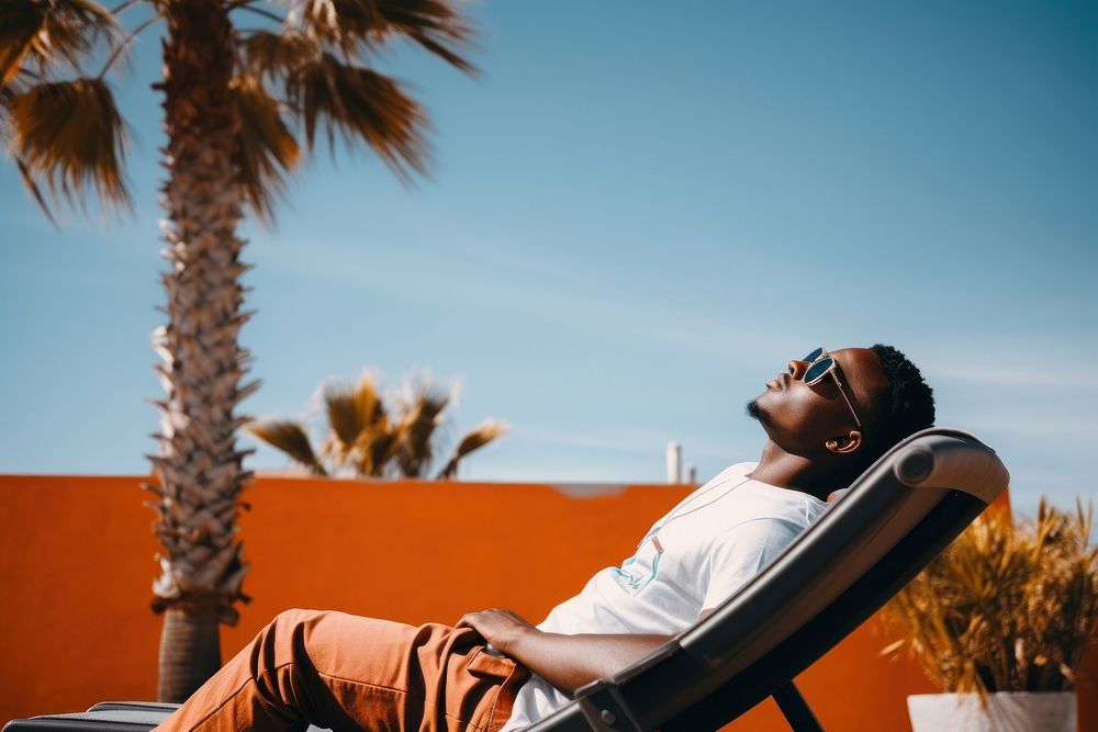African american man sitting sunbathing tranquility. AI generated Image by rawpixel.