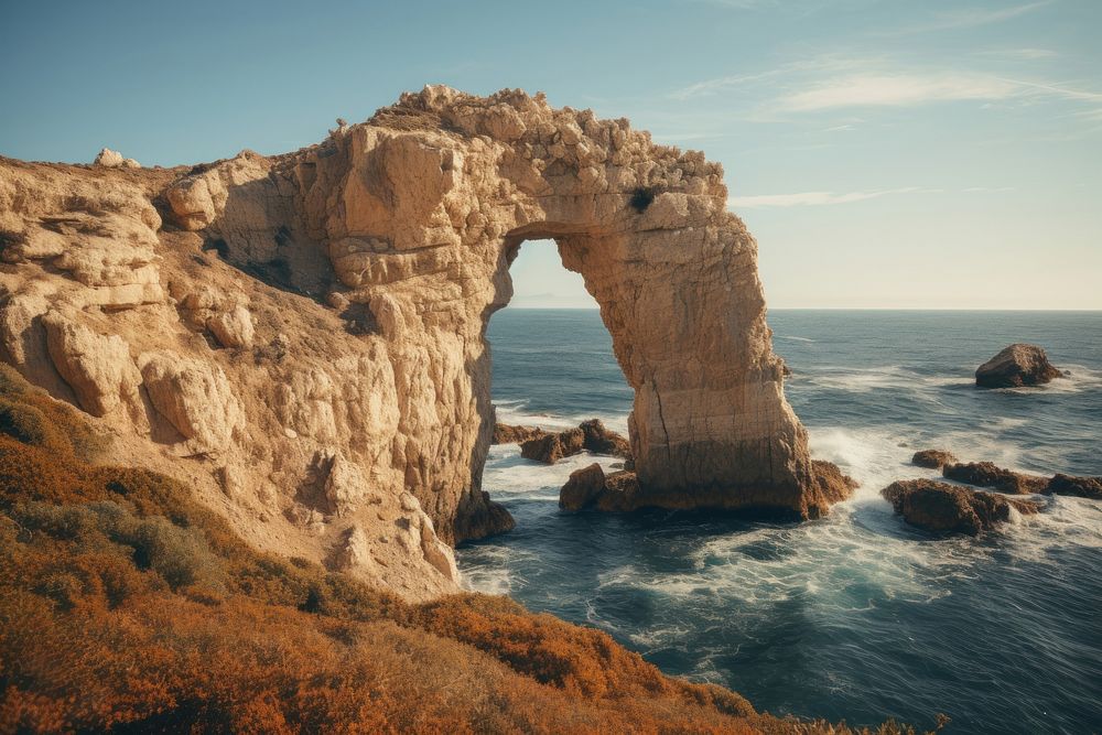 Arch formation landscape cliff sea. AI generated Image by rawpixel.