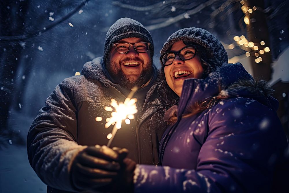 Couple holding glow sticks outdoors laughing winter. AI generated Image by rawpixel.