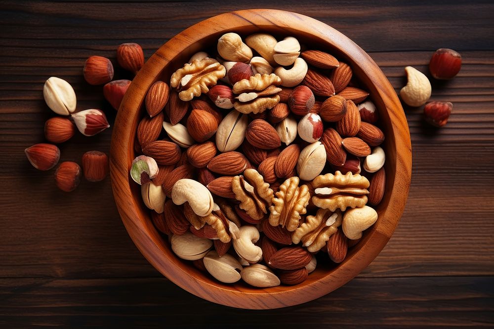 Assorted nuts bowl table plant. AI generated Image by rawpixel.