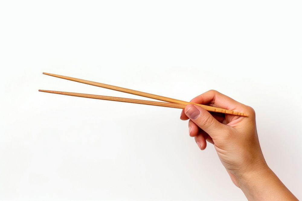 Chopsticks hand white background weaponry. AI generated Image by rawpixel.
