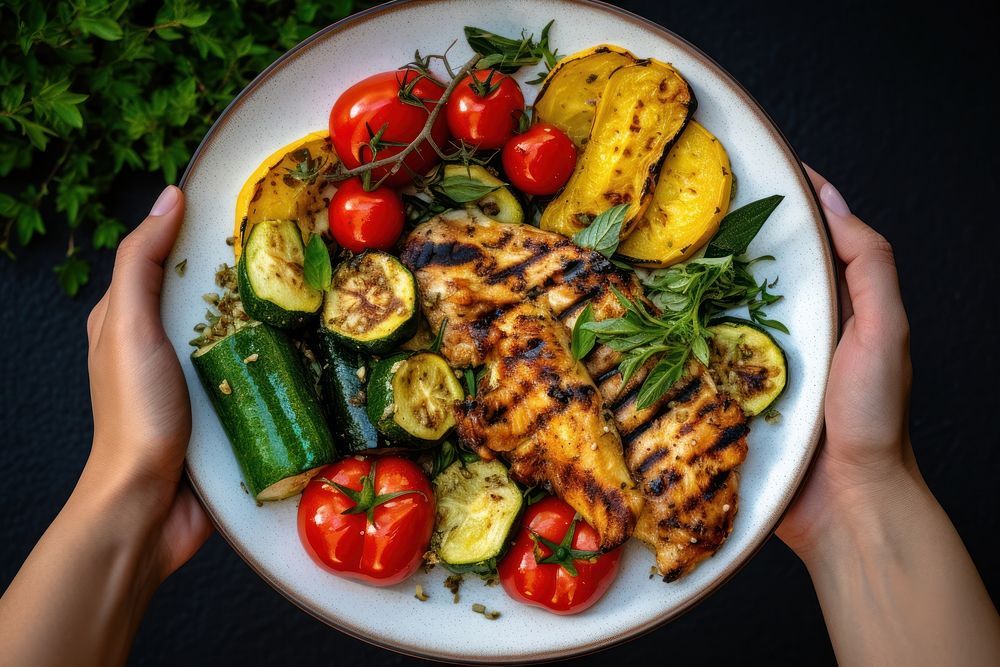 Grilled chicken plate vegetable holding. AI generated Image by rawpixel.