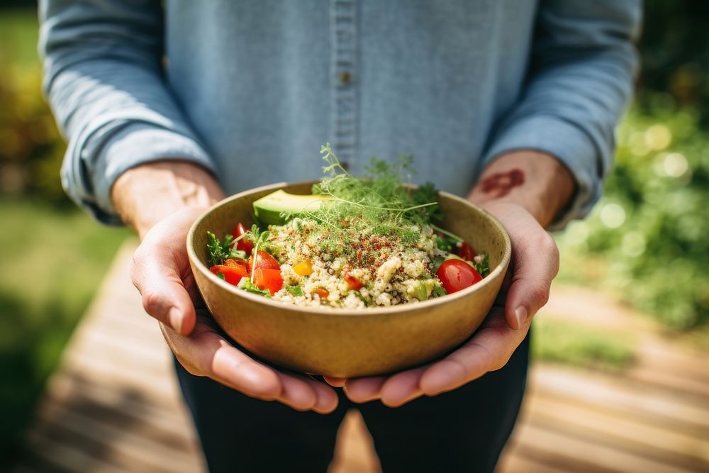 Quinoa salad holding food hand. AI generated Image by rawpixel.