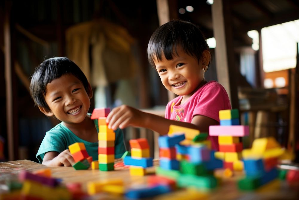 South east asia Children Playing With colorful Toy Blocks child toy play. AI generated Image by rawpixel.