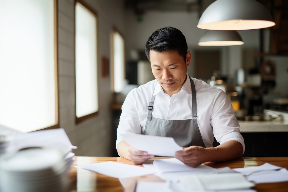 Stress asian small business owner restaurant holding reading. AI generated Image by rawpixel.