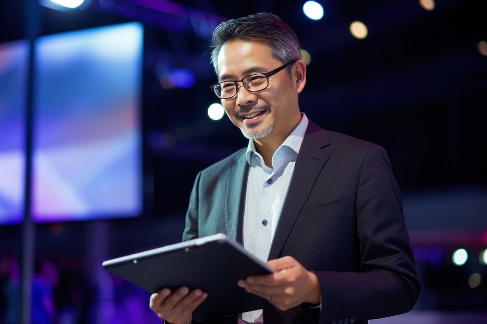 Middle age japanese CEO holding a tablet computer glasses adult. AI generated Image by rawpixel.