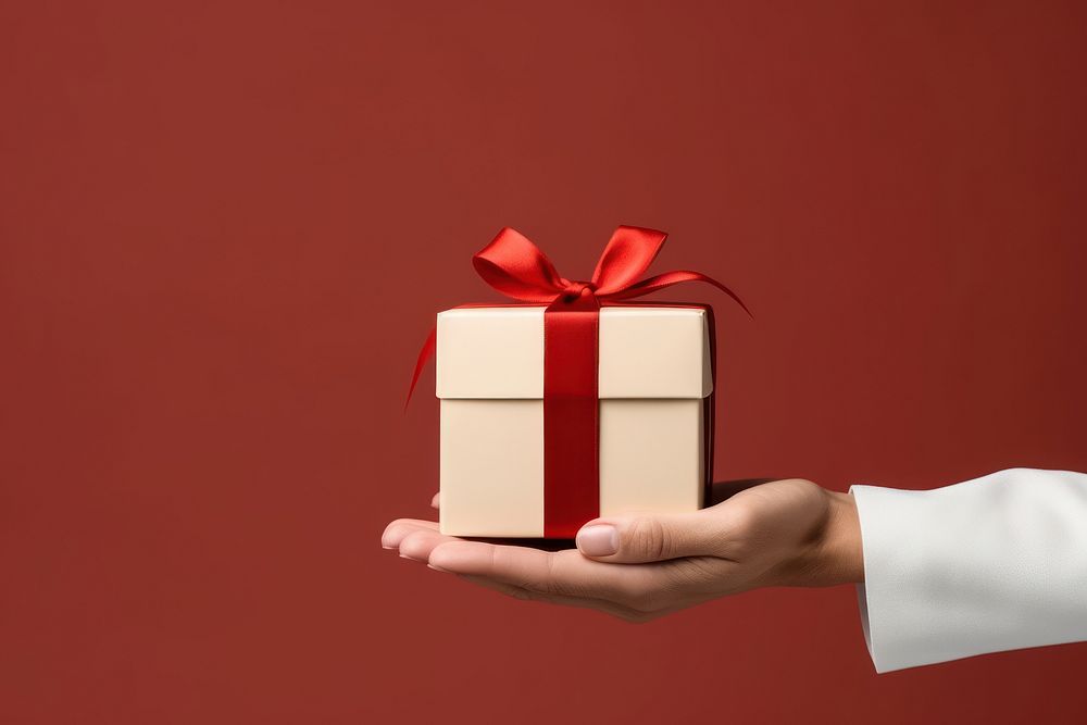 White gift box hand red celebration. AI generated Image by rawpixel.