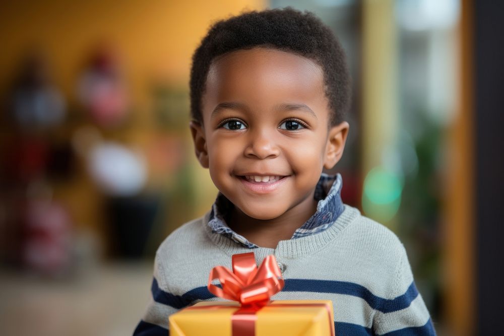 Happy kid holding a gift cheerful portrait smile. AI generated Image by rawpixel.