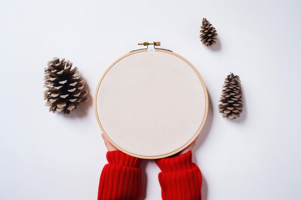 A hand holding embroidery christmas pattern white background. AI generated Image by rawpixel.