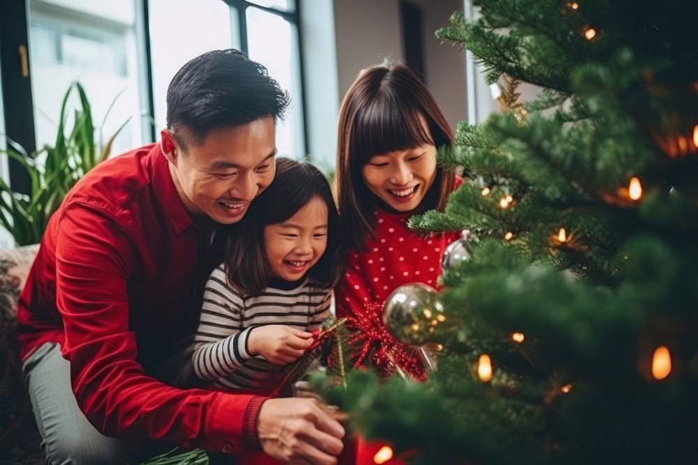Asian family decorating christmas tree holiday adult child. AI generated Image by rawpixel.