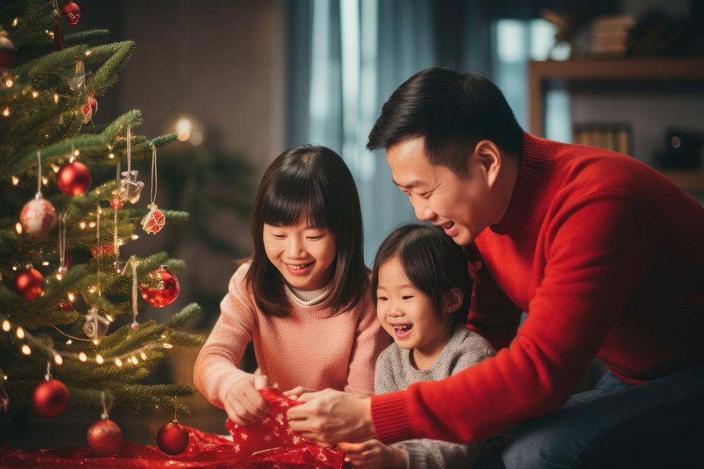 Asian family decorating christmas tree holiday adult red. AI generated Image by rawpixel.