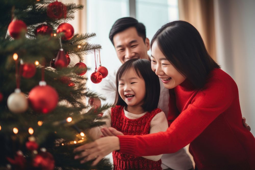 Asian family decorating christmas tree holiday adult togetherness. AI generated Image by rawpixel.