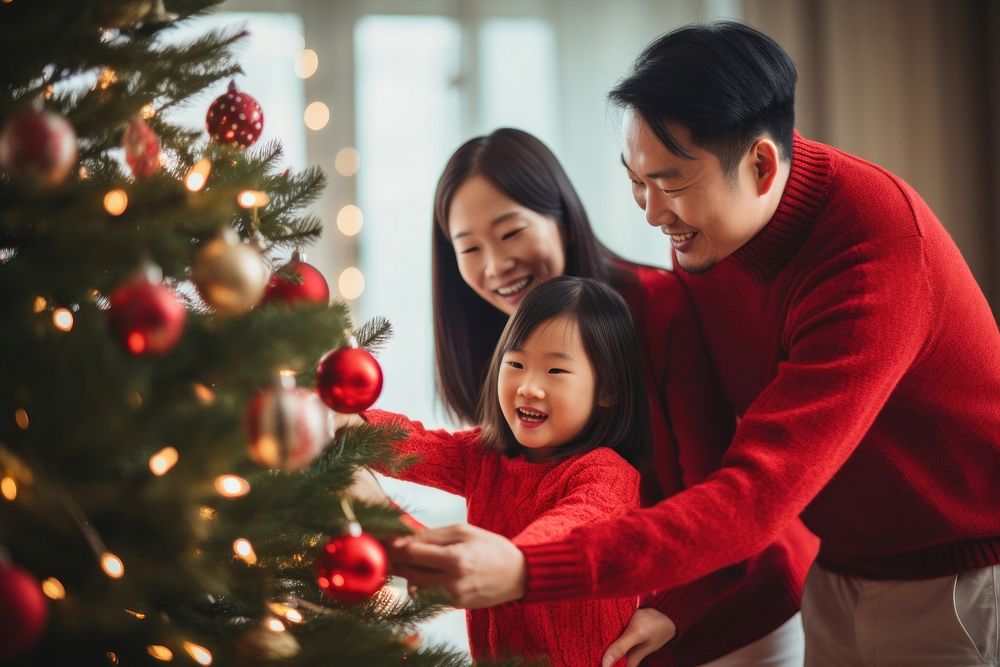 Asian family decorating christmas tree holiday adult red. AI generated Image by rawpixel.