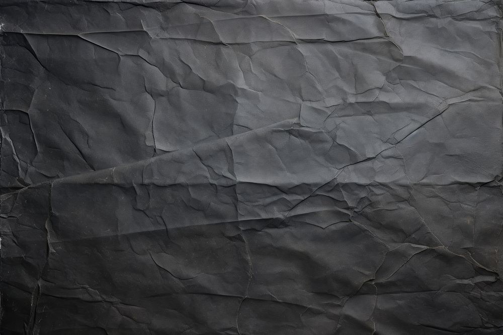 Black backgrounds wrinkled paper. 