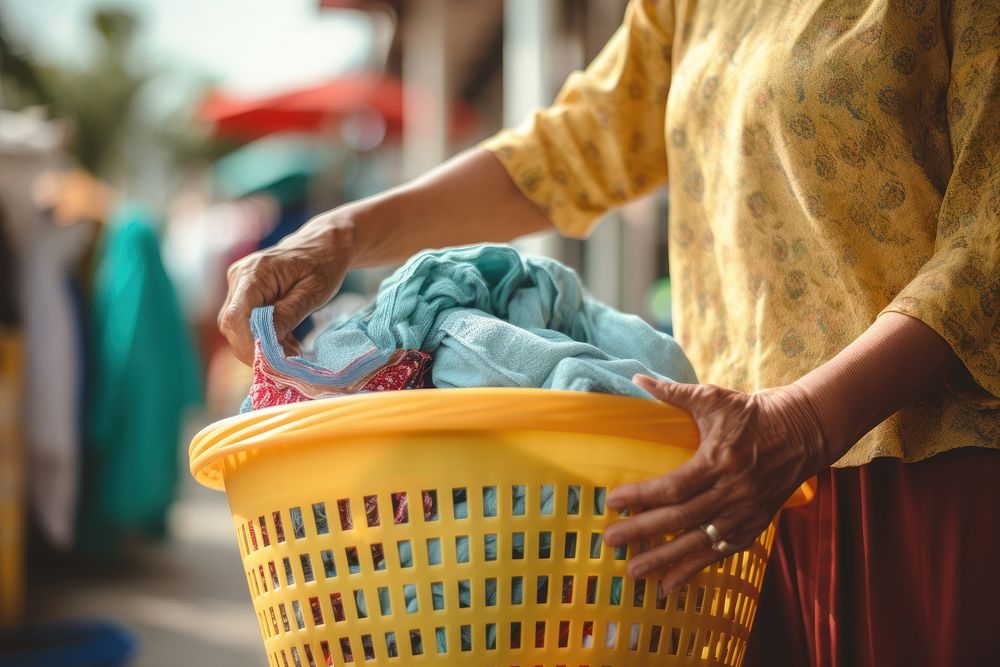 Woman holding laundry basket adult housework container. AI generated Image by rawpixel.