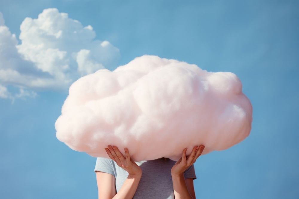 Hand holding big cloud pillow outdoors nature fluffy. AI generated Image by rawpixel.