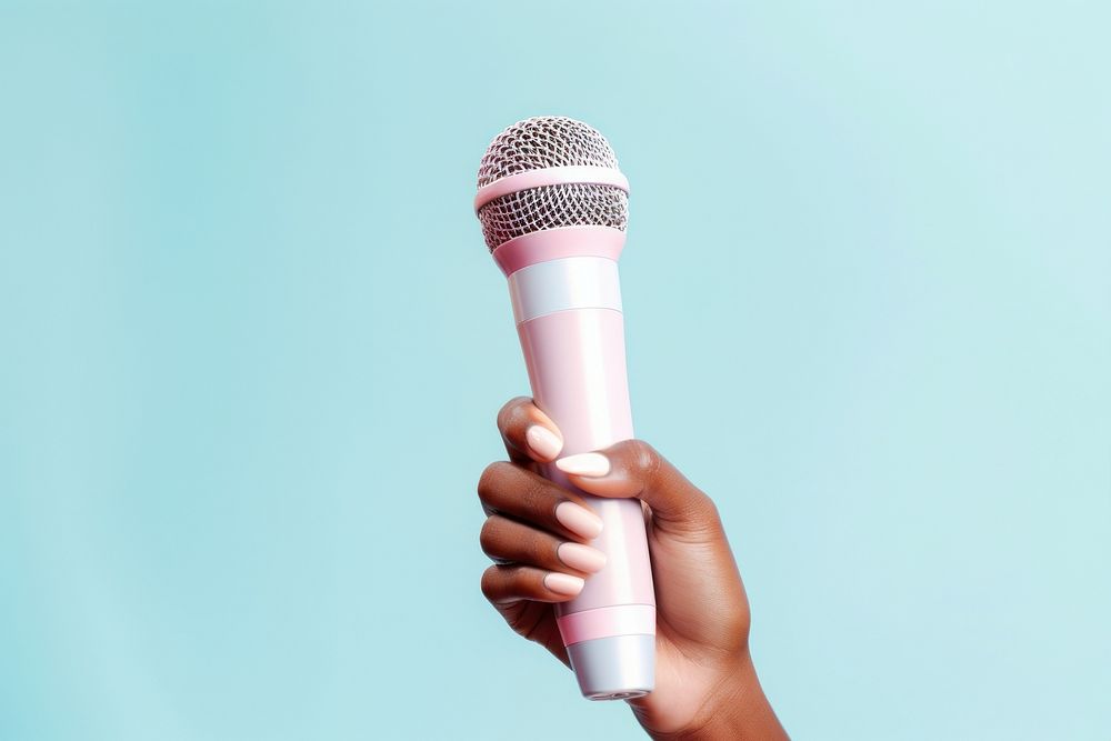 Hand holding microphone pink blue performance. AI generated Image by rawpixel.