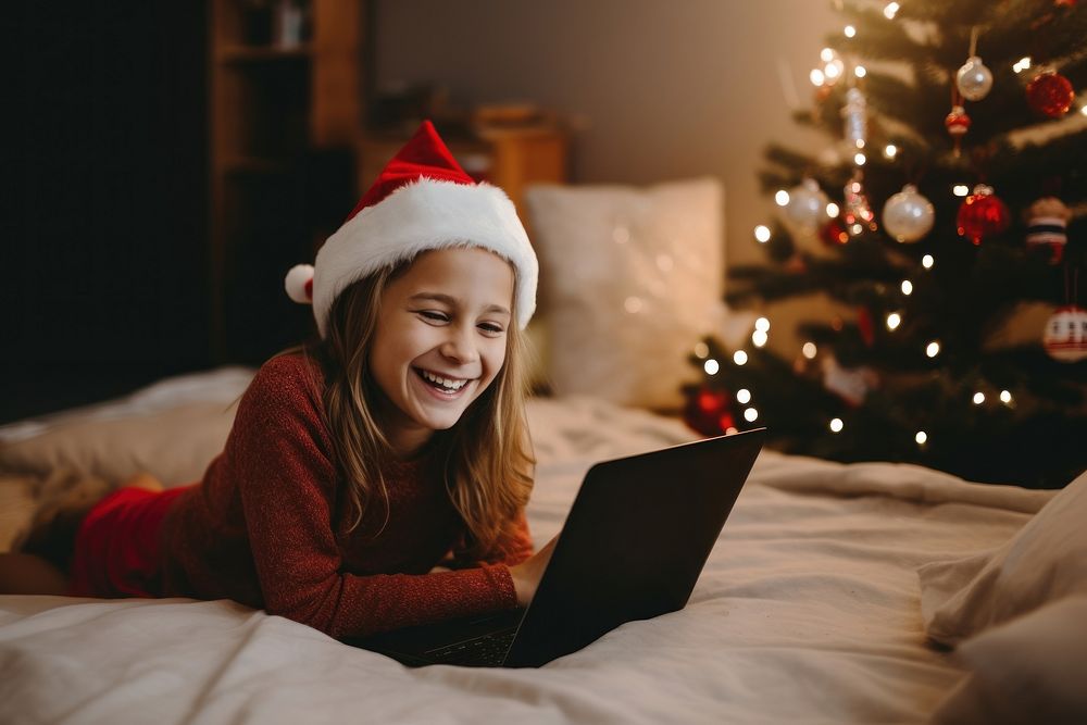 Girl having a Christmas video call christmas computer laptop. AI generated Image by rawpixel.