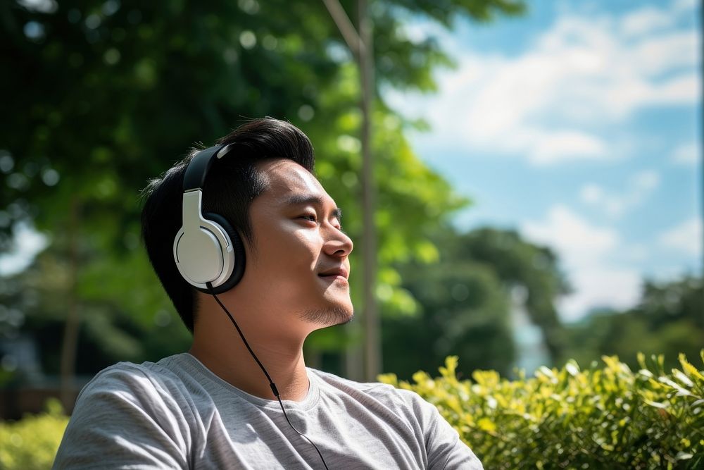 Singaporean man headphones listening headset. AI generated Image by rawpixel.