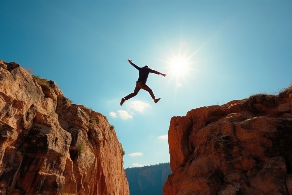 Man jump jumping cliff outdoors. AI generated Image by rawpixel.