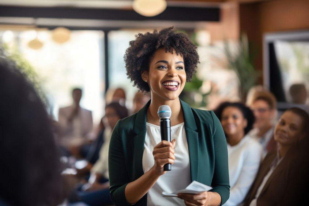 African american woman microphone audience smiling. 