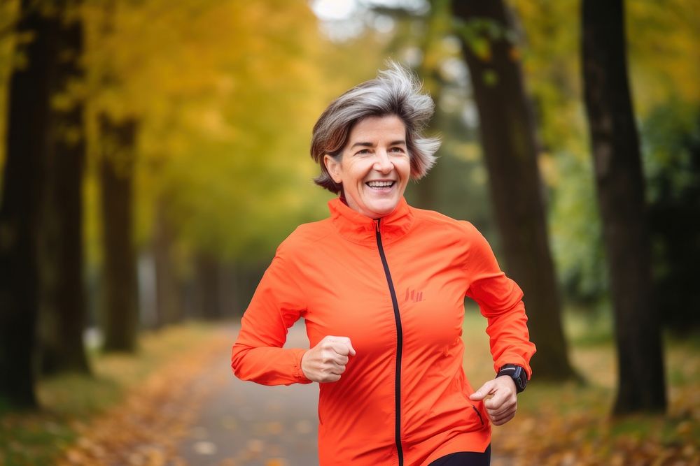 Middle age woman running jogging smiling. AI generated Image by rawpixel.