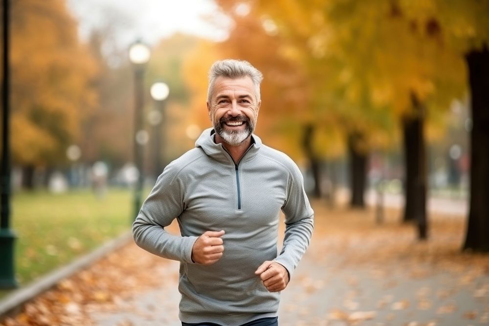 Middle age man running jogging smiling. AI generated Image by rawpixel.