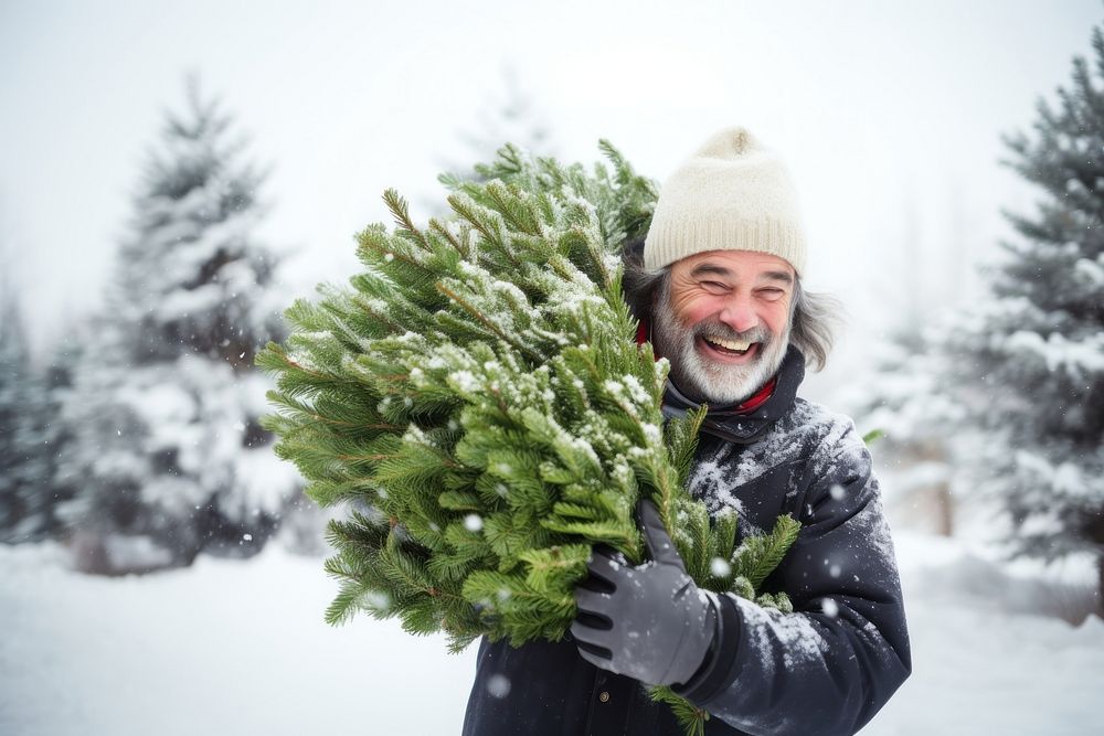 Middle age man carrying christmas tree snow portrait outdoors. AI generated Image by rawpixel.