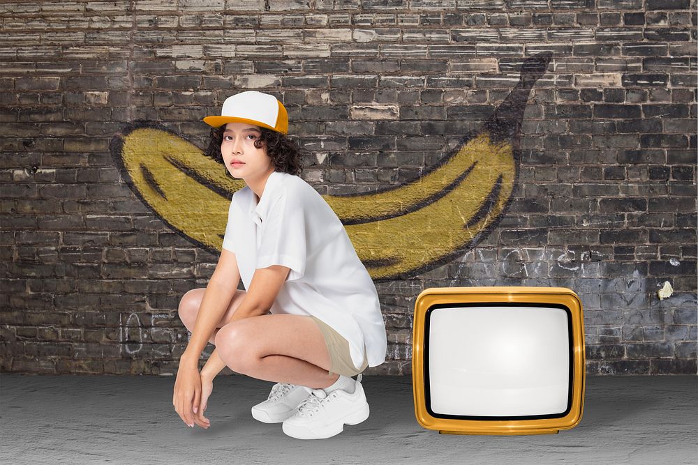 Cool girl in white shirt sitting by retro TV