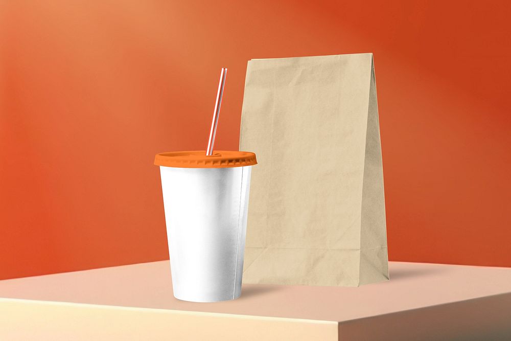 Orange soda cup and food bag