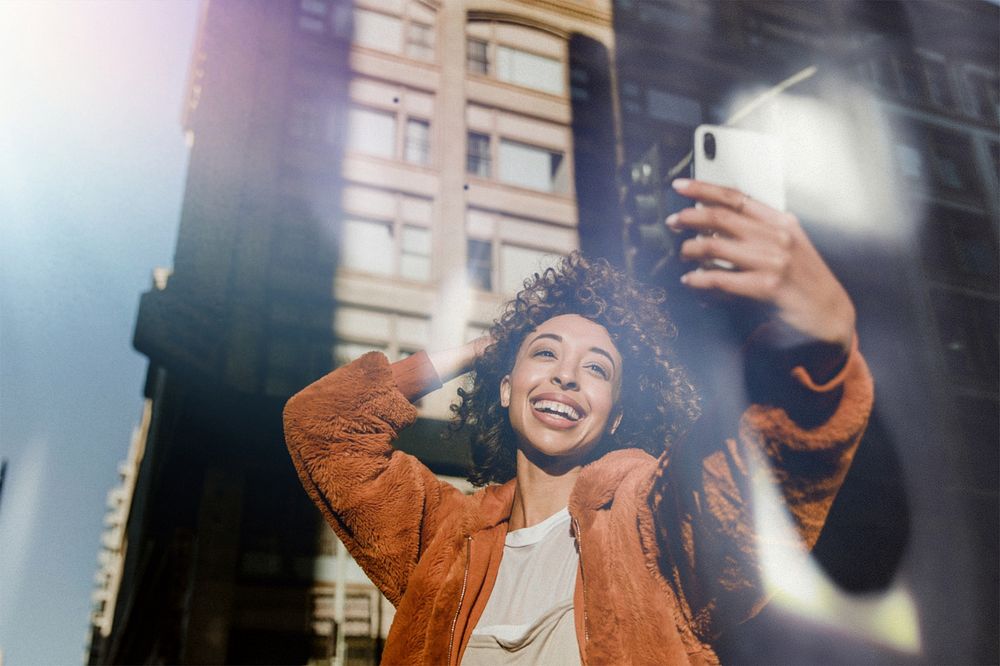 Woman taking selfie, light leak effect