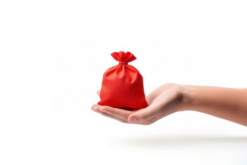 A tiny red money bag holding hand white background. AI generated Image by rawpixel.