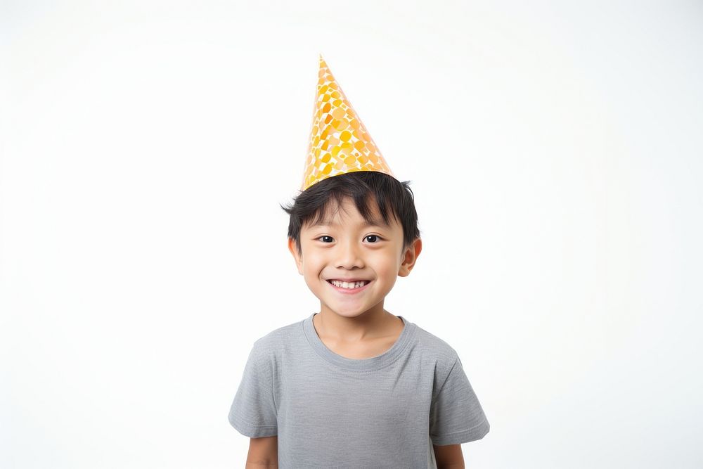 Southeastasian boy wearing party hat white background celebration anniversary. AI generated Image by rawpixel.