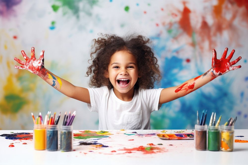 Little girl sitting at a table with stationery and paint child joy celebration. AI generated Image by rawpixel.