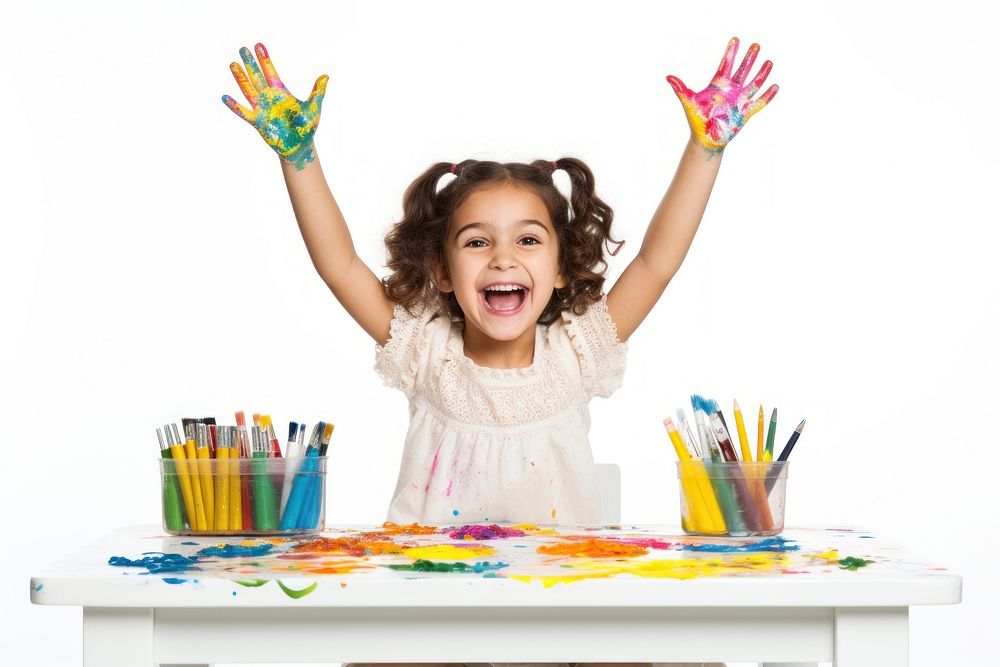 Little girl sitting at a table with stationery and paint portrait child hand. AI generated Image by rawpixel.