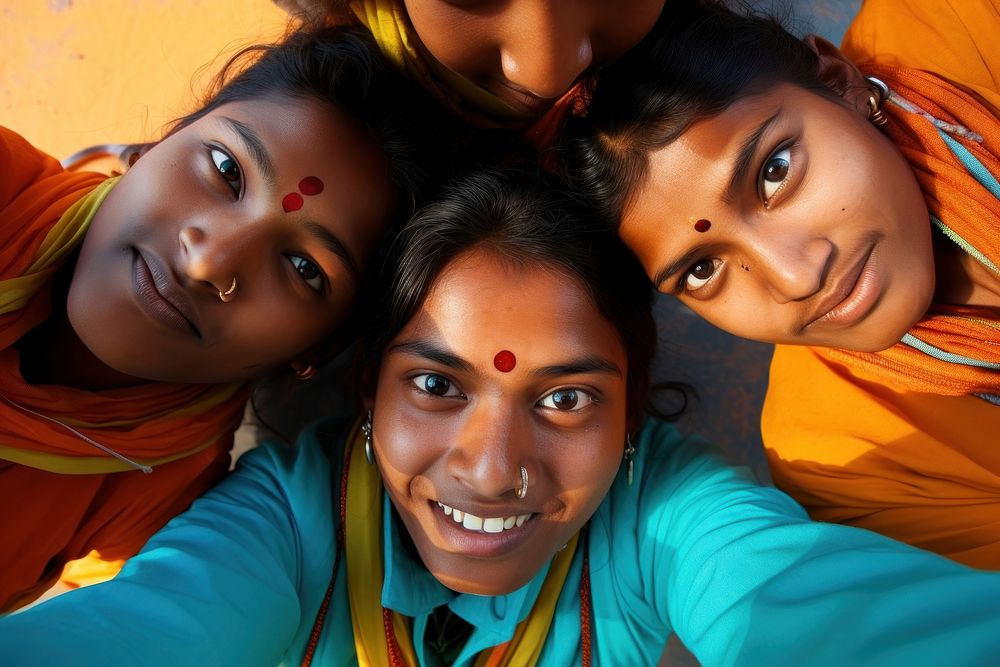 Four indians valunteer forming huddle portrait smile head. AI generated Image by rawpixel.