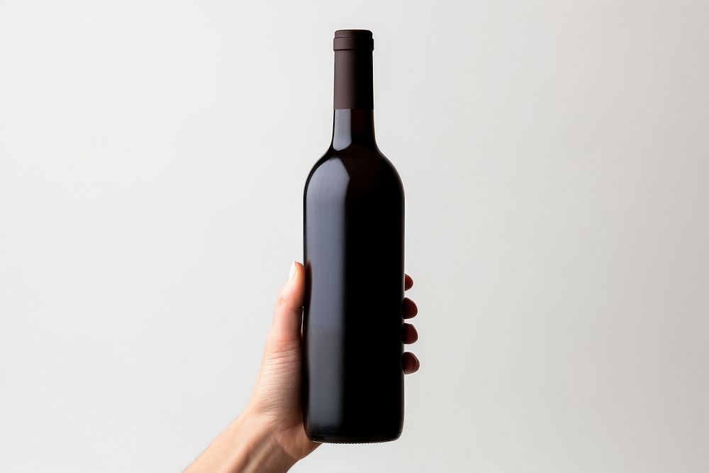Hand holding wine bottle drink refreshment drinkware. AI generated Image by rawpixel.