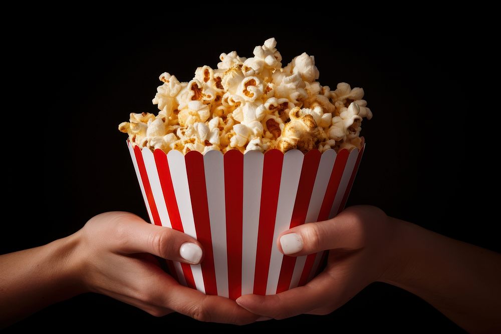 Popcorn box snack food hand. AI generated Image by rawpixel.