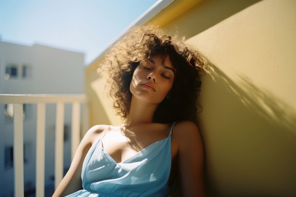 Woman is laying on a balcony preparing for the shoot portrait blue sky. AI generated Image by rawpixel.