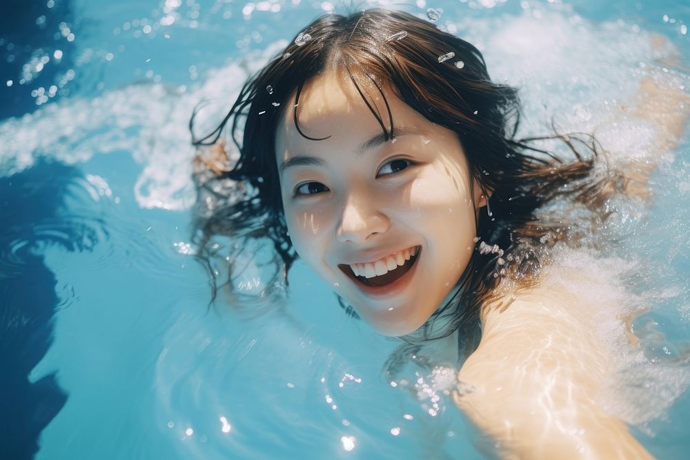Japanese girl swimming in the swimming pool looking happy and fun photography recreation portrait. AI generated Image by…