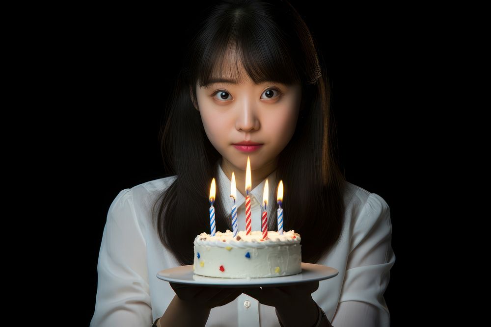 Young japanese Blowing out birthday candles dessert blowing party. AI generated Image by rawpixel.